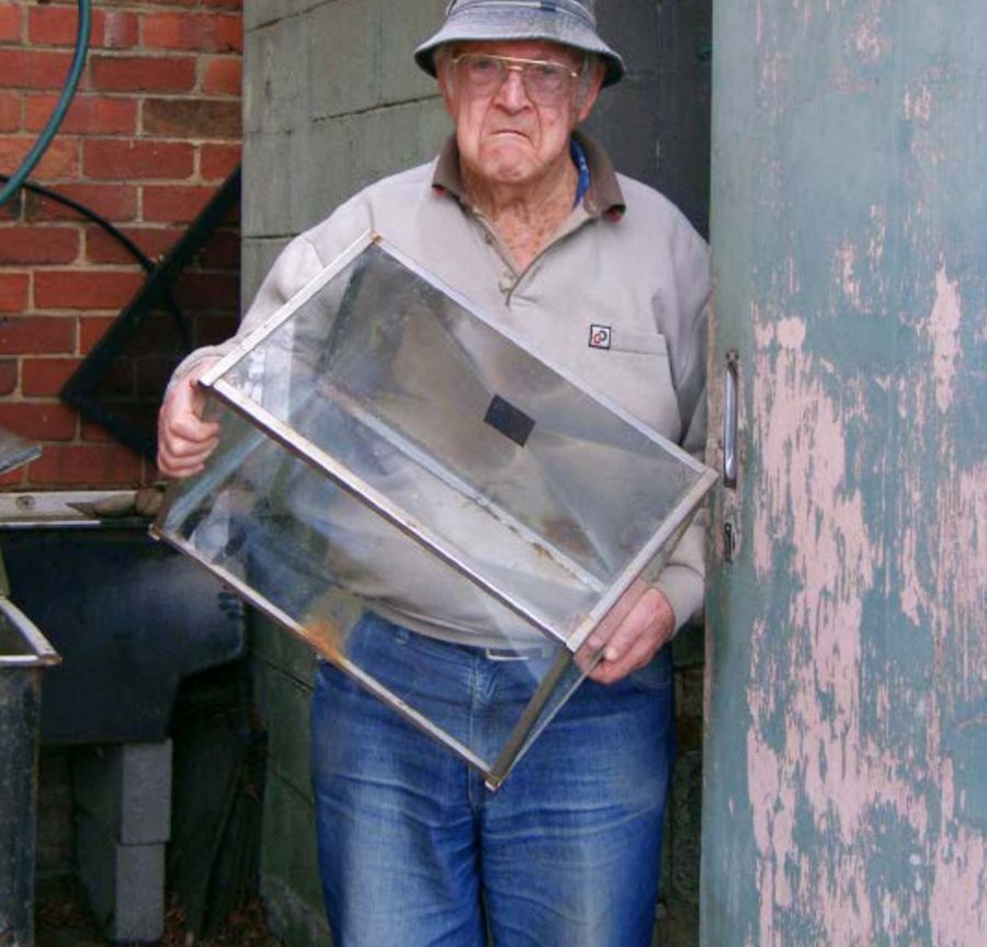 'Grumpy' Ron Bowman outside his Chadstone Road fishroom, posing for a VicNews promotional photo